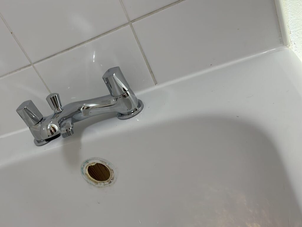 New chrome bath filler tap fitted to a white acrylic bath.